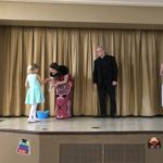 Father William Tourigny, pastor of St. Rose de Lima Parish in Chicopee, looks on during the kindergarten graduation ceremony at St. Joan of Arc School in Chicopee.