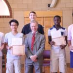 Members of the Cathedral Choir of Boys and Adults pose with organist and music director Lad Pfeifer (front center) during the choir's year-end event held at the Bishop Marshall Center adjacent to St. Michael's Cathedral in Springfield.