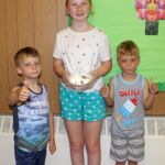 At the Holy Trinity, Westfield, Ice Cream Social, twins Nathan and Noah Hansen give a thumbs-up for the ice cream sundae served by Jessica Armstrong.