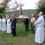 The Rosary Procession at St. Patrick Church in Monson pauses for prayer on the church grounds, on the hill overlooking the town's Main Street.