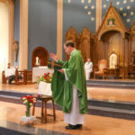 Msgr. Christopher Connelly, rector, offers a blessing during the Mass of Remembrance at St. Michael's Cathedral in Springfield.