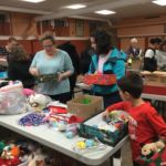 Toys, school supplies and hygiene items for children ages 2-14 will arrive someplace in the developing world for Christmas. Families at Mt. Carmel Parish, Springfield, had a shoe box packing party with these donated items.