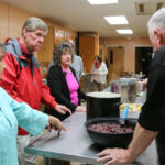 Volunteers work in the kitchen during the Harvest Supper at St. Michael's Cathedral Parish in Springfield.