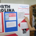 Fourth-grader Seth Tyrrell presents facts on North Carolina during State Box Exhibit Day at St. Joan of Arc School.