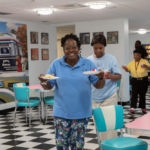 The Ladies of St. Peter Claver and the Gospel Choir from St. Michael's Cathedral Parish provide refreshments for residents of the Mason Wright retirement community in Springfield.