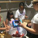 The youngest Take and Eat ministry helpers pack dessert and fruit at Mt. Carmel Parish, Springfield.