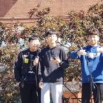 St. Mary Parish School's international students Jinlong, Jiarun and Yiran entertain the crowd with karaoke at last weekend's fall festival.
