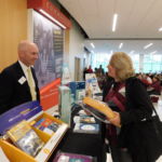 Jennifer Dean, preschool teacher and marketing coordinator at St. Stanislaus Kostka School in Adams visits a vendor during the annual Catholic schools in-service day held at Pope Francis Preparatory School in Springfield.