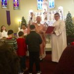 Stigmatine Father Robert White, pastor of Our Lady of Mt. Carmel Parish in Springfield, blesses parishioners' infant Jesus figures on Gaudete Sunday, the third Sunday of Advent. Known as the Bambinelli blessing, this is a papal custom introduced by Pope St. John Paul II.