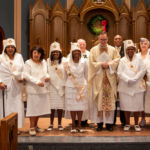 Newly installed officers and members of the Knights and Ladies of Peter Claver pose with Msgr. Christopher Connelly, rector, and Deacon Leo Coughlin at St. Michael's Cathedral in Springfield.