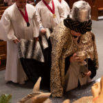 St. Michael's Cathedral boys choir members assist one of the Three Kings during the celebration of the feast of the Epiphany.